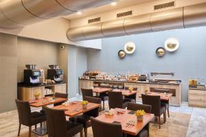 a restaurant with tables and chairs and a counter at Catalonia Gracia in Barcelona