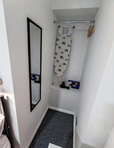 a small hallway with a mirror and a stairway at Rose Studio - Self Contained Studio Flat in Oxford