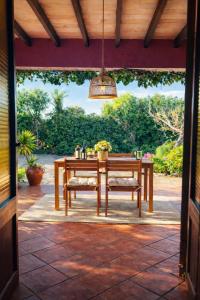 a wooden table and chairs on a patio at Villa Es Puig, piscina y vistas a la montaña in Santa Margalida