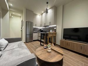 a living room with a couch and a table at Olive City Suites in Larisa