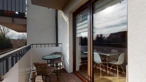 a balcony with a table and chairs on it at Apartament Fibra Crema in Rybnik