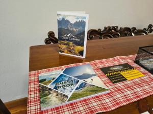 two brochures sitting on top of a table at Ciasa Cadorina - Relax nelle Dolomiti in Pelos
