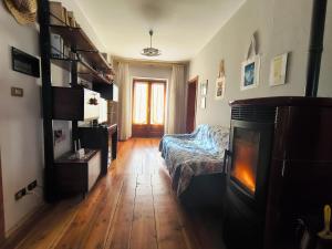 a living room with a couch and a fireplace at Ciasa Cadorina - Relax nelle Dolomiti in Pelos +24 photos