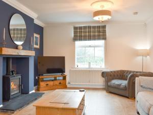 a living room with a couch and a table at Fern House in Hinderwell