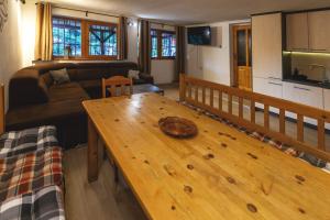 a living room with a wooden table and a couch at Chata Malino in Ružomberok