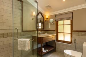 a bathroom with a sink and a glass shower at The Hill Club - Nuwara Eliya in Nuwara Eliya +82 photos