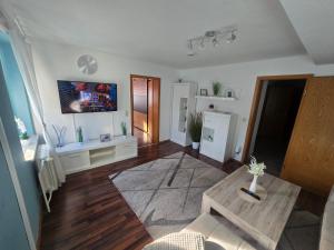 a living room with a couch and a table at Ferienwohnung, Apartment, Monteurwohnung mit Klimaanlage Wettin-Löbejün in Gottgau