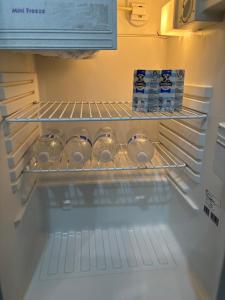 an empty refrigerator with its door open with food at Guest ensuite room with private entrance in Melbourne