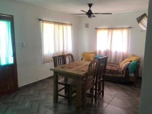 a dining room with a table and chairs and a couch at Lujan de cuyo 2 in Ciudad Lujan de Cuyo