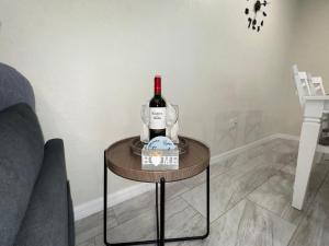 a bottle of wine on a table in a living room at Sunshine Nest in Lehigh Acres +22 photos