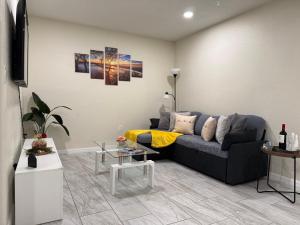 a living room with a couch and a table at Sunshine Nest in Lehigh Acres