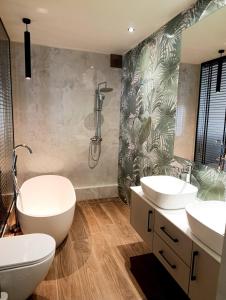 a bathroom with two sinks and a shower at Olive City Suites in Larisa +25 photos