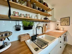 a kitchen with a sink and a counter at Honey Gardens venkovský apartmán v přírodní zahradě in Oleška