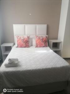 a bedroom with a bed with two pillows at Ekhenani Guest House in Nongoma