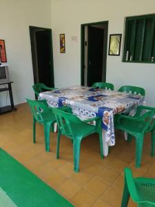 a table with green chairs and a table cloth on it at punta bolivar in San Antero