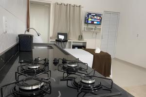 a kitchen with four burners on a stove top at Apartamentos Vitória – Conforto e Excelente Localização in Barreirinhas +127 photos