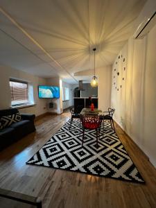 a living room with a table and a couch at KATO Central 3 - 100m2 - Self check-in - Air Condition in Katowice