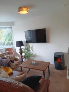 a living room with a couch and a fire place at The Studio in Windermere