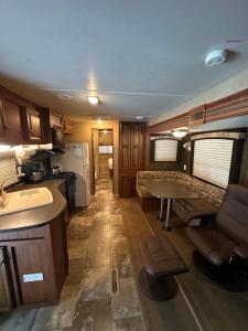 a kitchen and living room of an rv at Rustic cozy couples summer stay in Little Current
