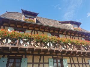 a building with flower boxes on the side of it at Hôtel Restaurant AU SOLEIL in Wahlbach
