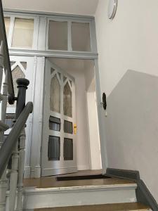 a stairway leading to a door in a house at Das MONTI - Superior in Stendal