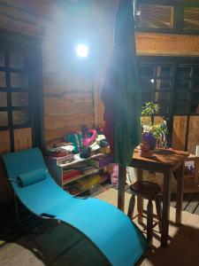 a room with a blue chair and a table at Casa Hostal Familiar Espacio SaTaNaMa in El Torreón +36 photos