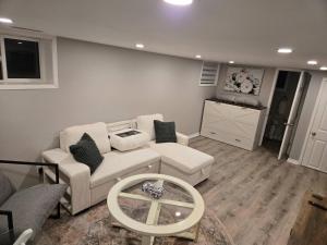 a living room with a couch and a table at Cozy East Hill 2026 in Belleville