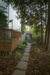a garden with a wooden deck and a patio at Cozy East Hill 2026 in Belleville