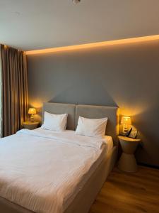 a bedroom with a large bed with two pillows at Hayat Hotels & Apartments in Rust +60 photos