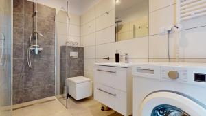 a bathroom with a washing machine and a shower at Studio Fibra Barista in Rybnik +28 photos