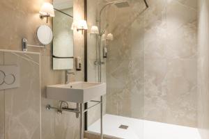 a bathroom with a sink and a shower at Hotel Avalon Paris Gare du Nord in Paris +42 photos
