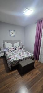 a bed in a room with a purple curtain at Plaza de la Cruz, 2 in Cazalegas