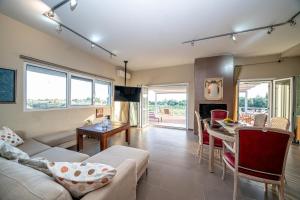 a living room with a couch and a table at Villa Sorina Kefalonia in Svoronata