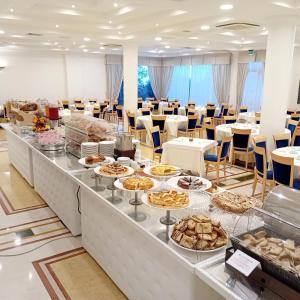 a buffet line with many different types of pastries at Hotel Relais dei Normanni in Monte SantʼAngelo
