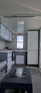 a small kitchen with white cabinets and a sink at catamaran nautilodge in Sainte-Anne +19 photos