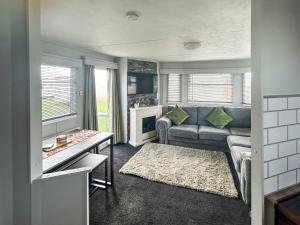a living room with a couch and a table at Emily's Van in Skegness