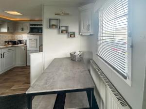 a kitchen with a table in the corner of a room at Emily's Van in Skegness