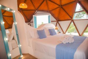 a bedroom with a bed in a tent at Cipó Cabanas in Santana do Riacho +92 photos