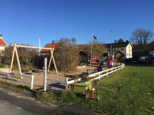 a park with a swing set and a playground at Kustnära Vandrarhem in Hamburgsund