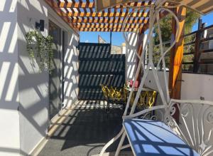 a porch with chairs and a wooden pergola at Younis chalet in Dahab