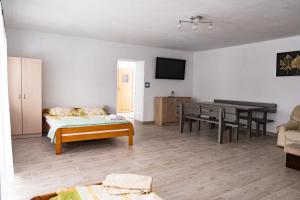 a living room with a table and a dining room at Domek Ranczo in Mochnaczka Wyżna