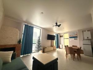 a living room with a couch and a table at Marhaba Villa in Borjomi +3 photos