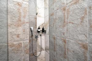 a shower with two bottles on a wall at Апарт-отель ЛЕВЕЛ Ереван, Ханджян 47 in Yerevan