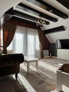 a living room with a couch and a table at Poarta Raiului in Tău Bistra