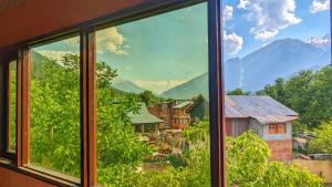a view from a window of a village at Tip Top Pahalgam in Pahalgām