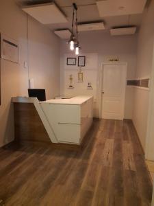 an office with a desk in a room with wooden floors at Scenery Maqalika Guesthouse in Maseru +20 photos