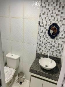 a bathroom with a toilet and a sink at Recanto da Lú Casa - Salvador in Salvador