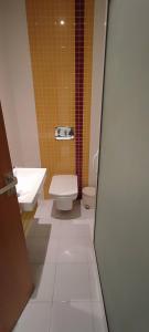 a bathroom with a toilet and a sink at Panamera vue mer 180 degré in Sousse