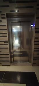a glass shower in a room with a ceiling at Panamera vue mer 180 degré in Sousse