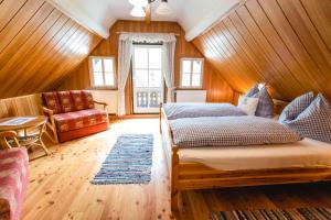 a bedroom with a bed and a couch at Haunzwickl Ferienhaus in Mürzzuschlag